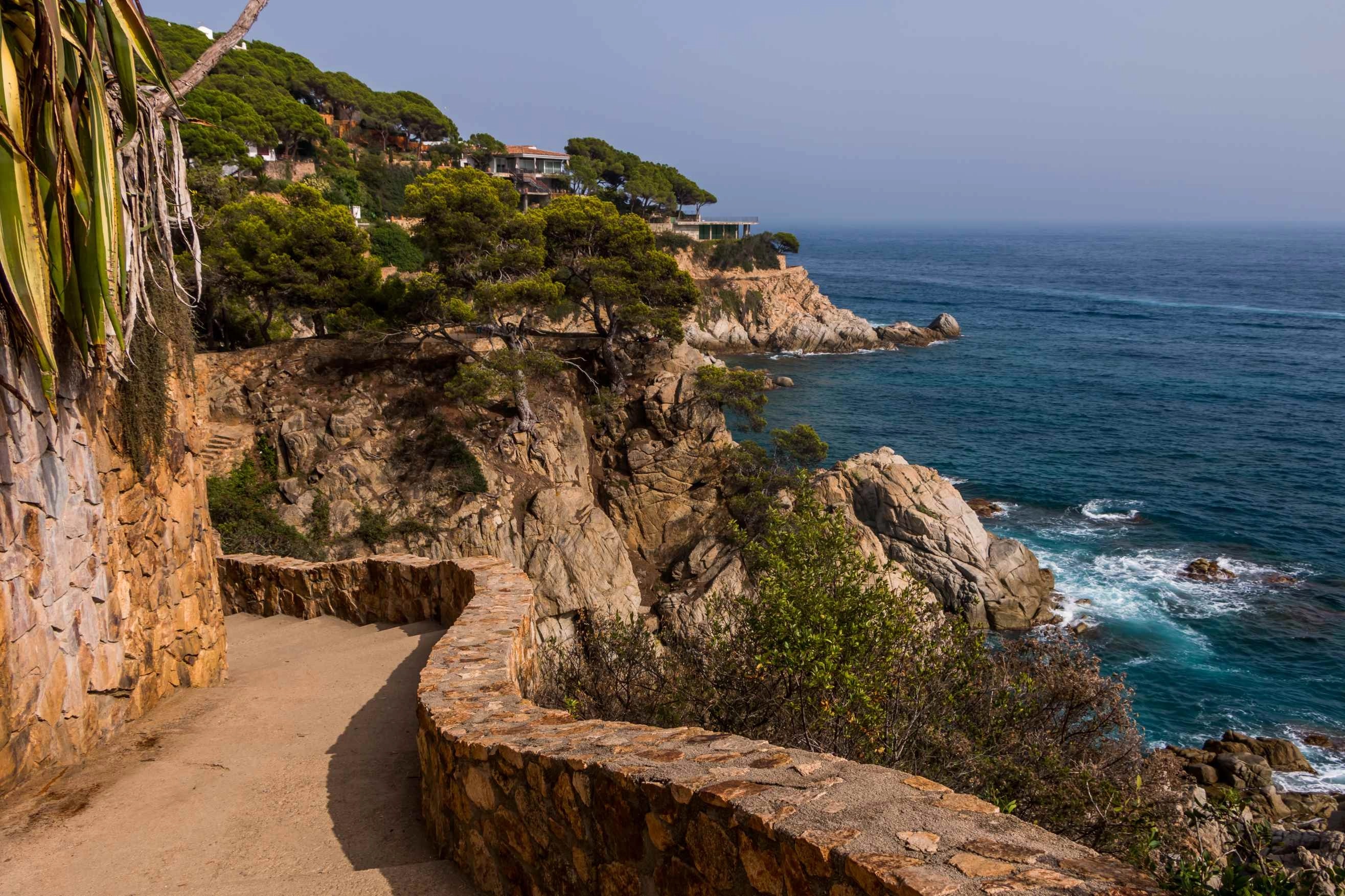 Costa Brava crystal clear turquoise cove with cliffs and Mediterranean beach Spain
